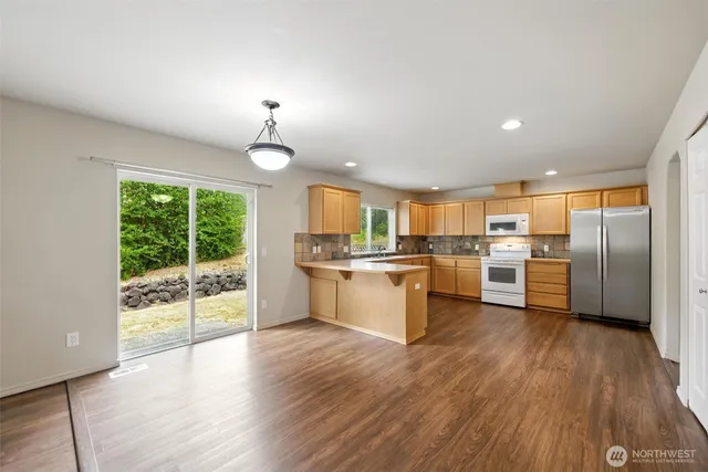 a kitchen with a refrigerator and white cabinets