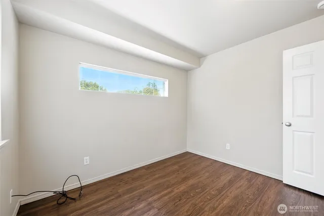 a view of a room with wooden floor