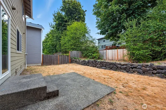 a backyard of a house with a tree
