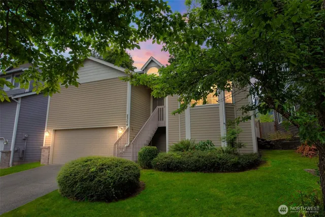 a front view of a house with a yard and a garage