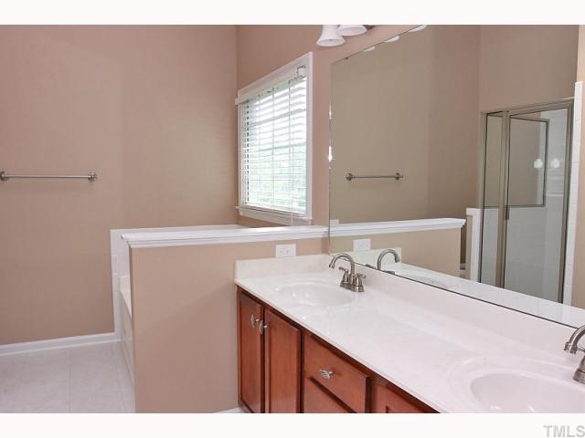 4320 Bartholomew Circle Raleigh, NC 27604 - Photo 6 of 11 a bathroom with a sink vanity granite and a mirror