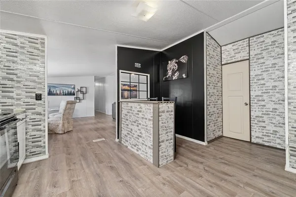 a view of a kitchen with furniture and wooden floor