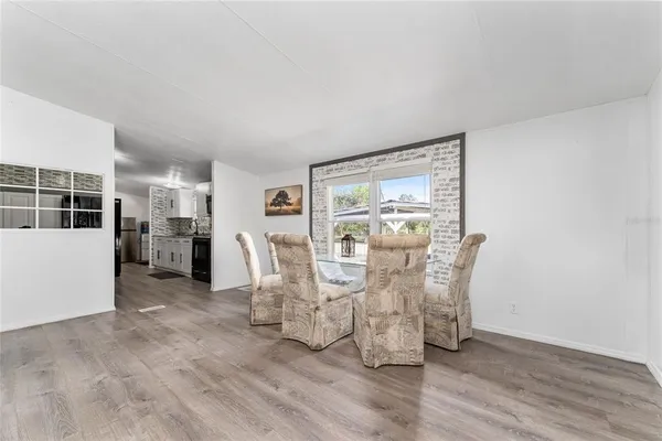 a dining room with furniture and wooden floor