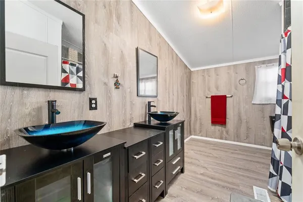 a kitchen with granite countertop a sink a stove and wooden floor