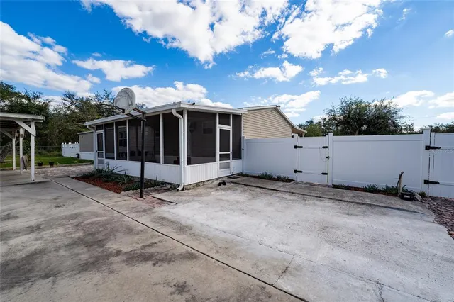 a view of a barn with wooden fence