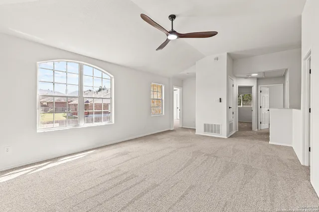 a view of livingroom with a ceiling fan and window
