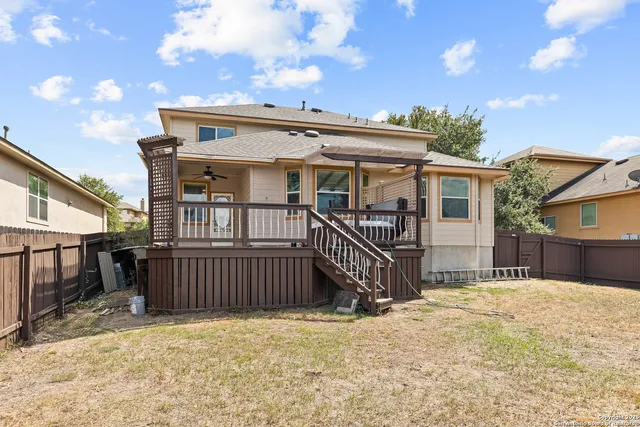 a view of a house with a wooden roof and wooden fence