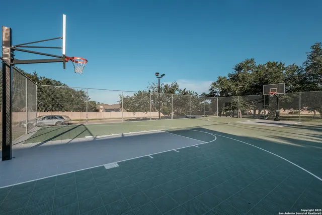 a view of building with river and trees in the background