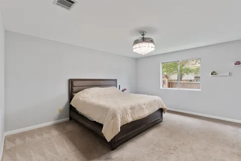 a bed sitting in a bedroom next to a window
