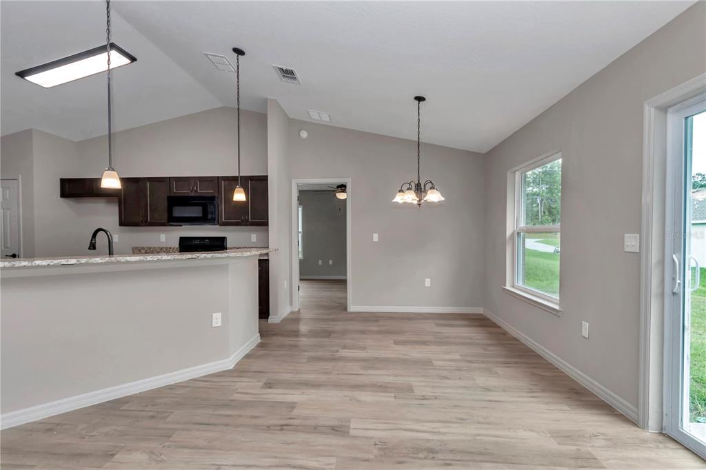 12841 Southwest 83rd Terrace Ocala, FL 34473 - Photo 8 of 31 a view of a kitchen with a sink wooden floor and a window