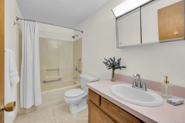 a bathroom with a sink toilet and shower