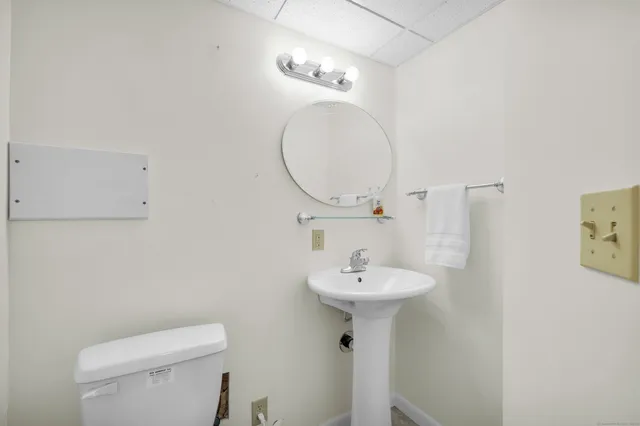 a bathroom with a sink a mirror and toilet