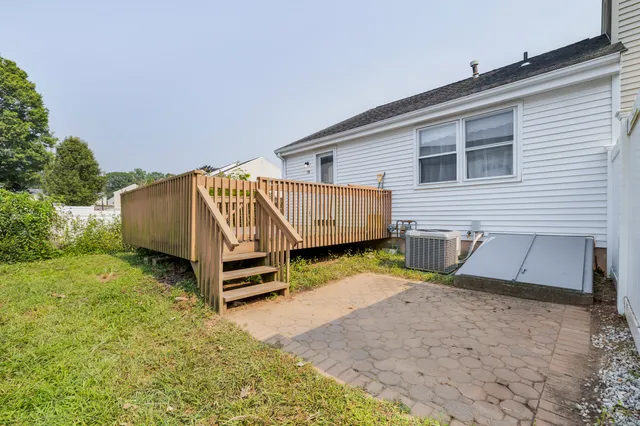 a view of a house with a yard and wooden fence