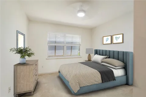 a bedroom with a bed and a potted plant