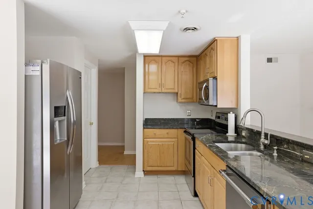 a view of an empty room with a fireplace and a window