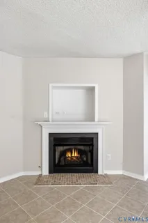 a view of an empty room with a fireplace
