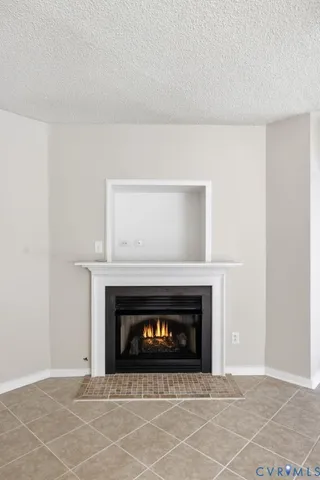 a view of an empty room with a fireplace