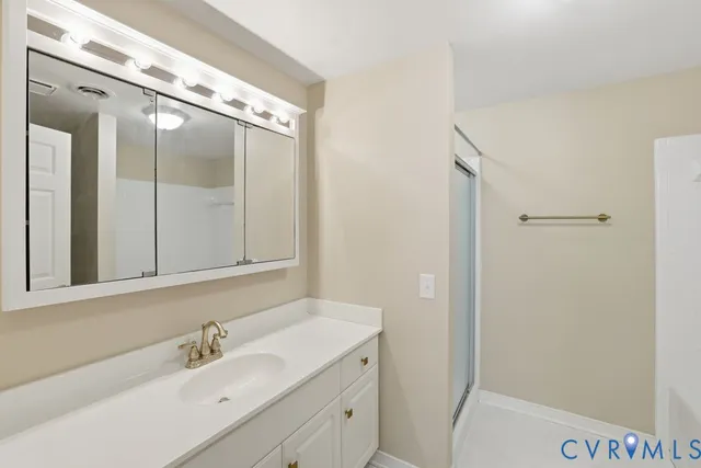 a bathroom with a double vanity sink and mirror with shower