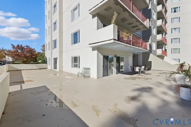 a view of a patio with couches table and chairs and potted plants