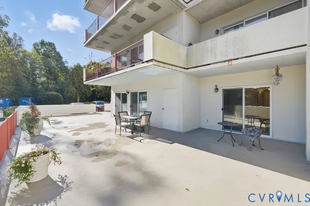 a view of a chairs and table in the balcony