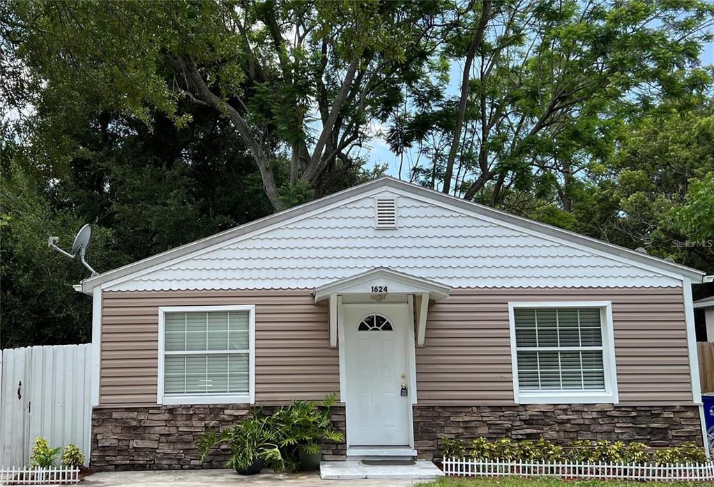 a front view of a house with a garden