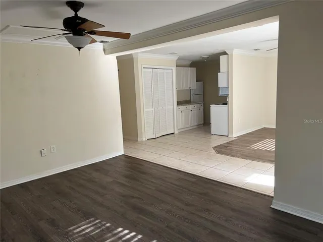 a view of empty room with wooden floor