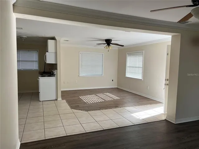 a view of empty room with wooden floor
