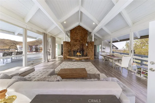 a large bedroom with a large bed and a view of living room