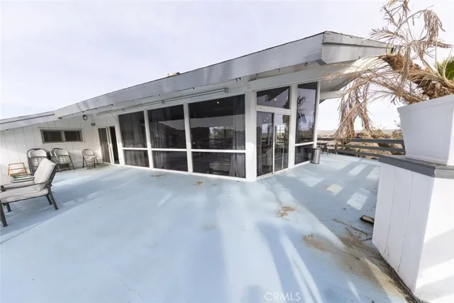 a spacious bedroom with a bed and a wooden floor