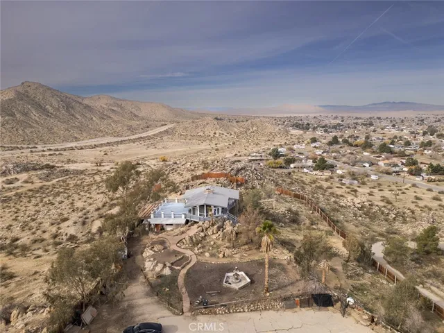 a view of a yard with wooden fence