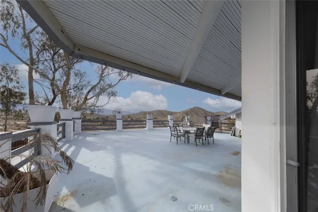 a view of a backyard with a table and chairs