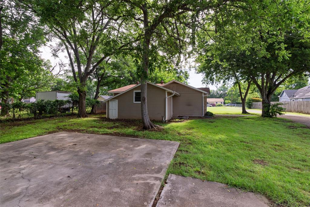 313 North Roe Street White Settlement, TX 76108 - Photo 25 of 33 Expansive concrete pad with surrounding green lawn and mature trees