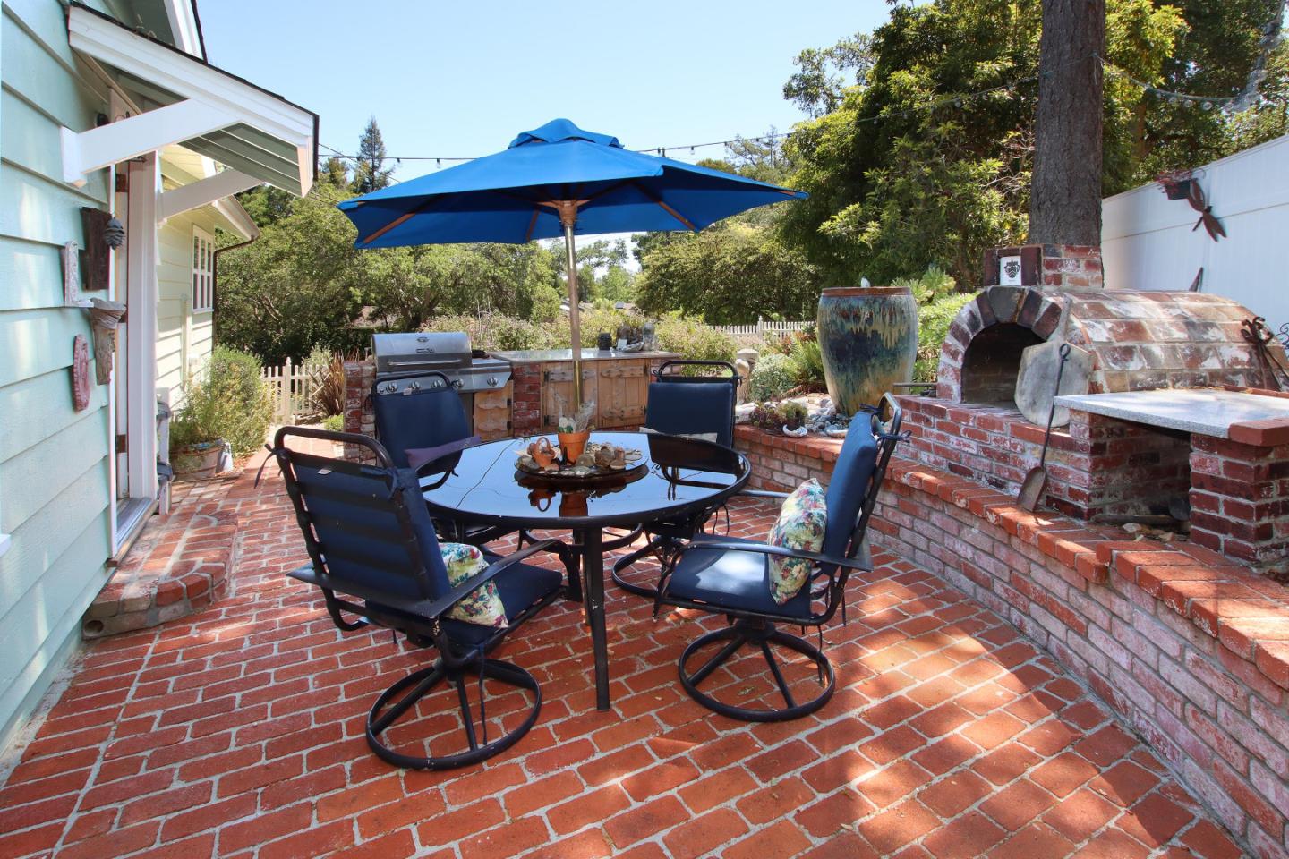 2 Deer Path Road Santa Cruz, CA 95060 - Photo 35 of 44 a view of a patio with a table and chairs under an umbrella
