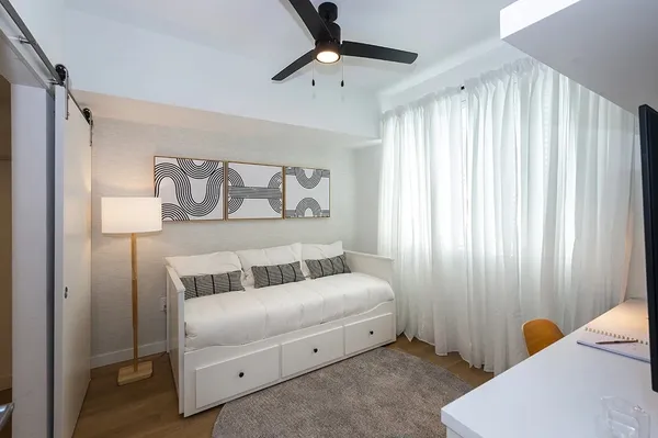 a bedroom with a bed and a chandelier