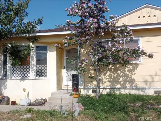 a view of a house with a tree