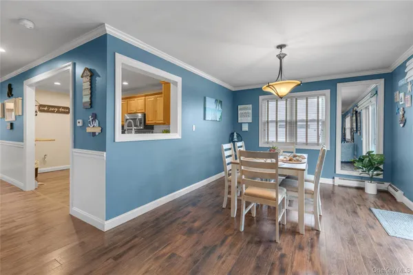 a view of a livingroom with furniture wooden floor and a window