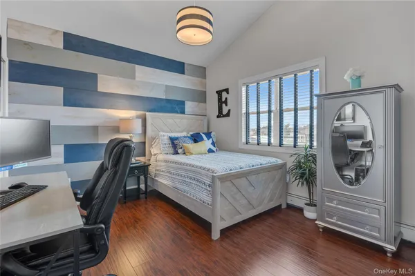 a bedroom with a bed and a lamp