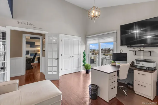 a view of a livingroom with workspace and a window