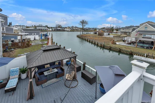 a view of a roof deck with chair and wooden floor
