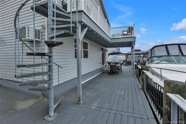 a roof deck view with table and chairs