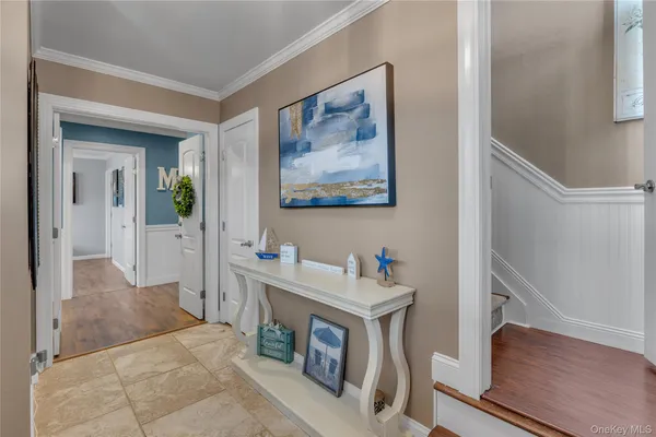 a hall with a sink and a mirror