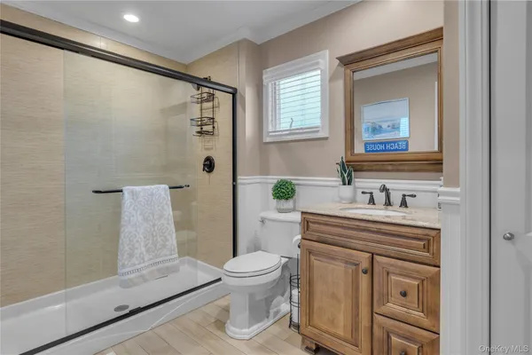 a bathroom with a sink a toilet and shower