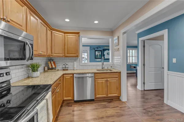 a kitchen with stainless steel appliances granite countertop a sink stove and refrigerator