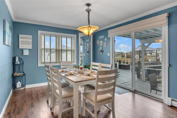 a dining room with furniture a chandelier and wooden floor