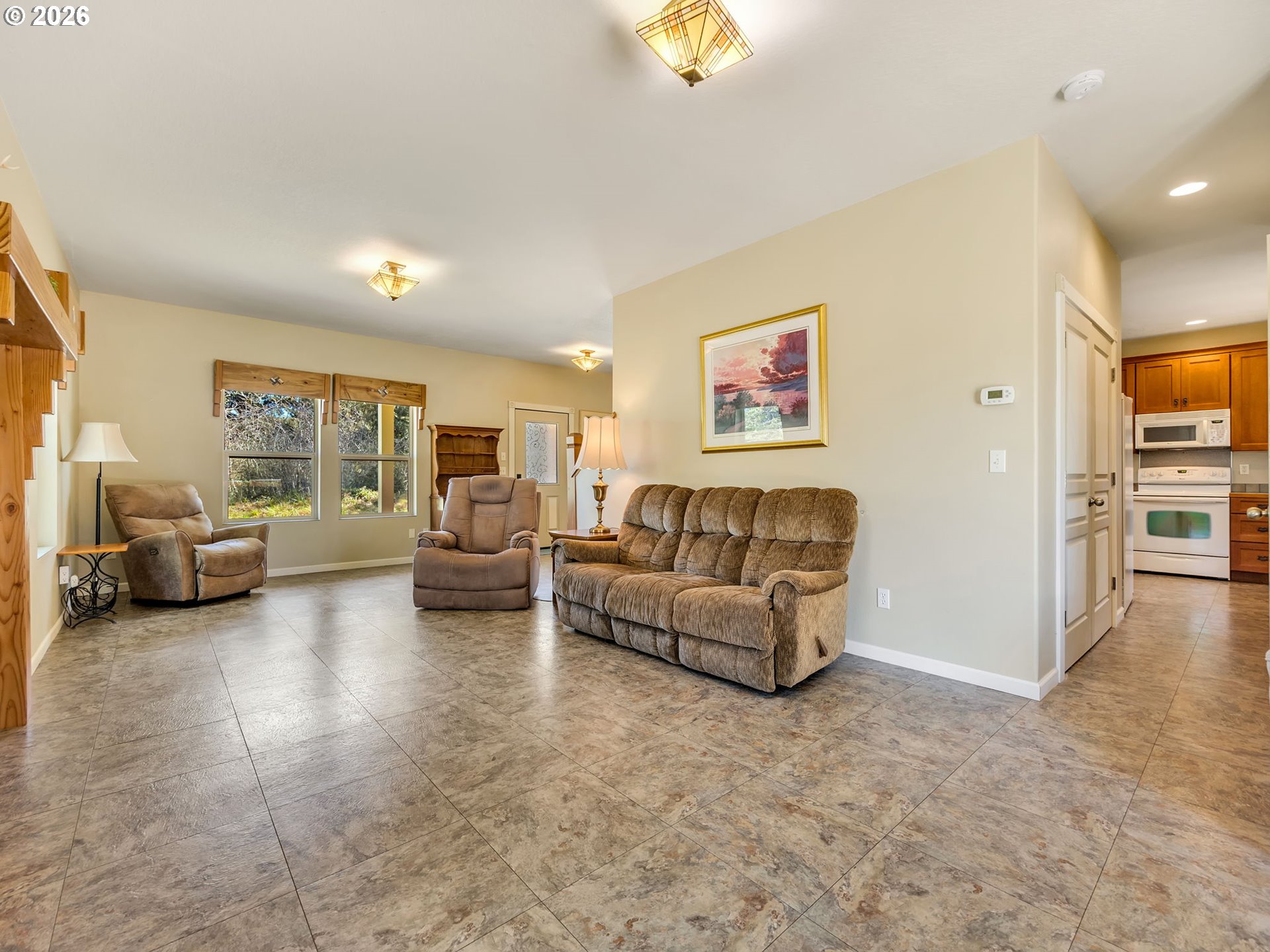 1077 Southwest Ridge Road Warrenton, OR 97146 - Photo 8 of 46 a living room with furniture and a flat screen tv
