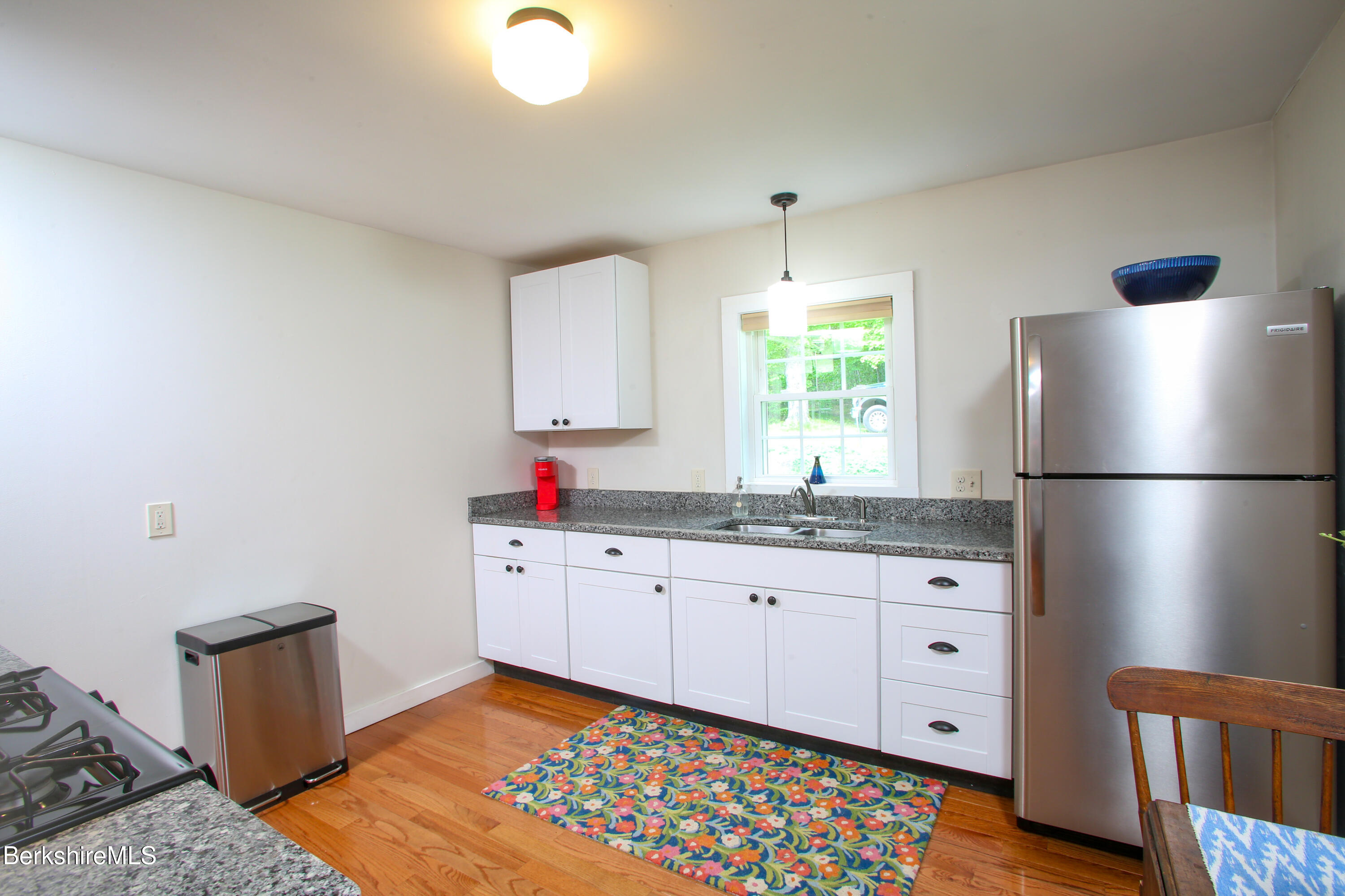 127 County Road Rowe, MA 01367 - Photo 12 of 29 a kitchen with granite countertop a sink cabinets stainless steel appliances and a window