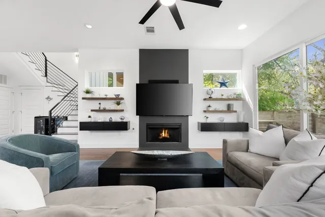 a living room with furniture fireplace and a flat screen tv