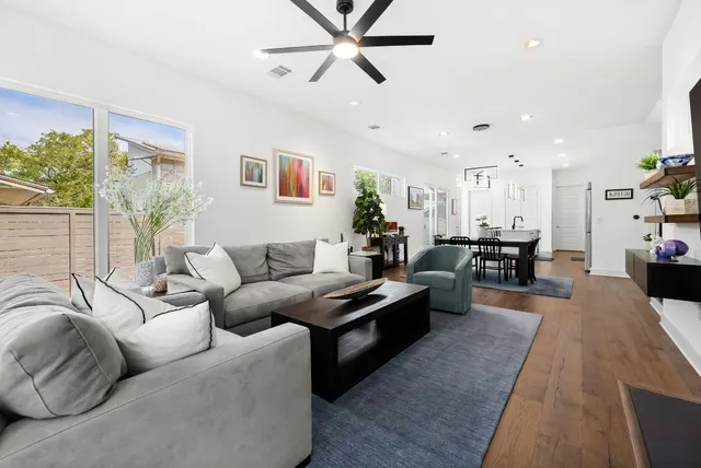 a living room with furniture a fireplace and a flat screen tv
