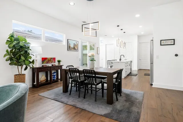 a living room with furniture kitchen view and a large window