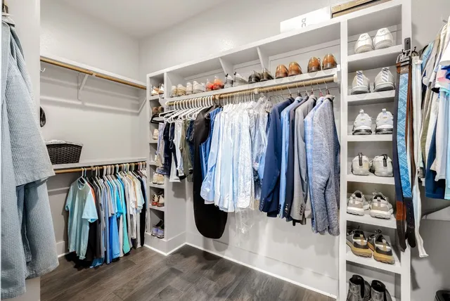 a spacious bathroom with a double vanity sink a mirror and a shower